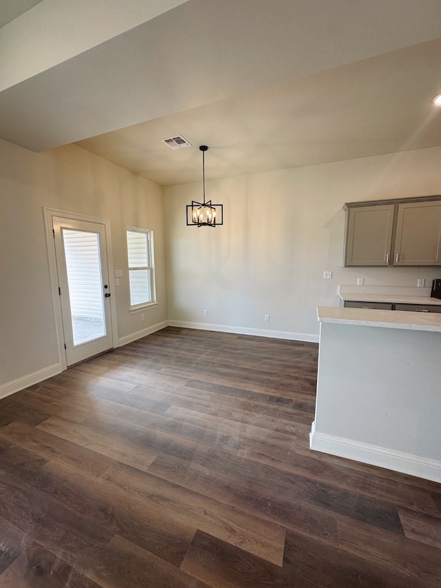 kitchen featuring baseboards, visible vents, hanging light fixtures, gray cabinets, and light countertops