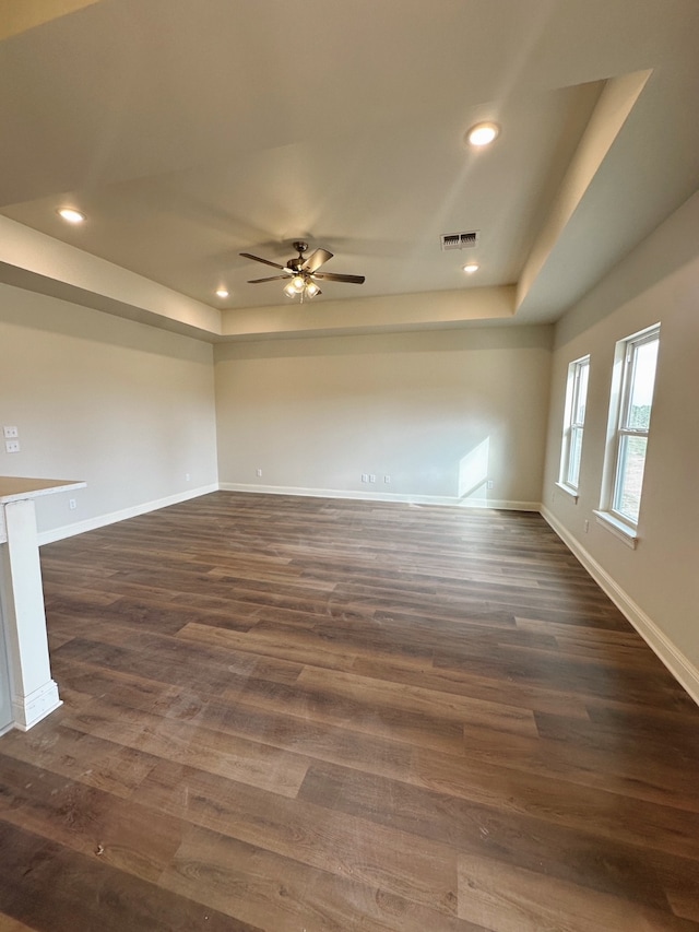 spare room with dark wood-style floors, recessed lighting, and baseboards