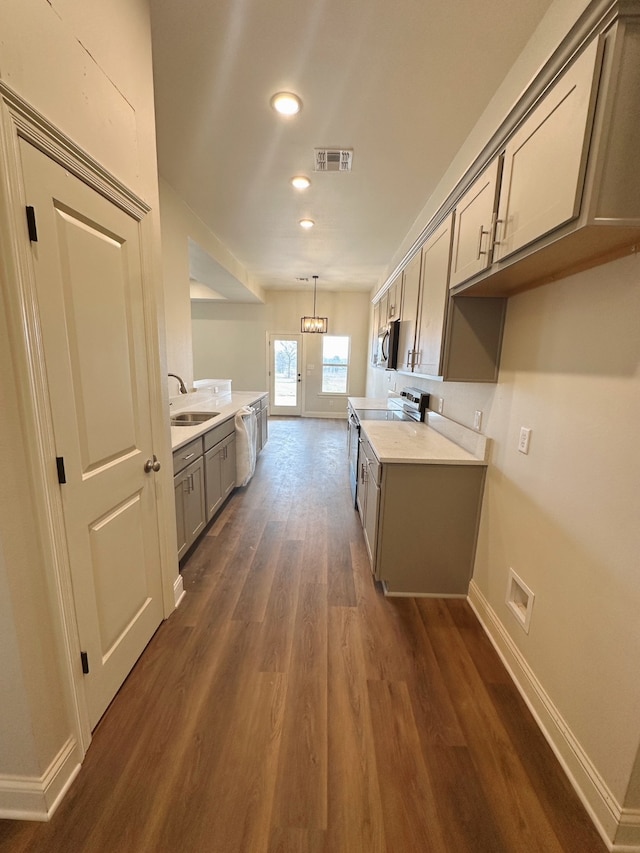 kitchen with a sink, visible vents, light countertops, appliances with stainless steel finishes, and gray cabinets