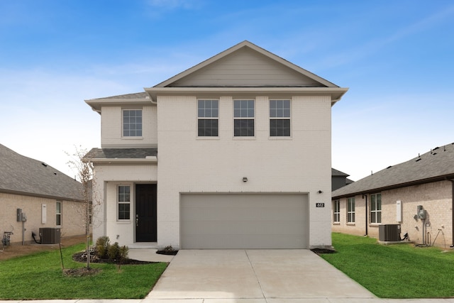 view of property featuring central AC unit, a garage, and a front yard