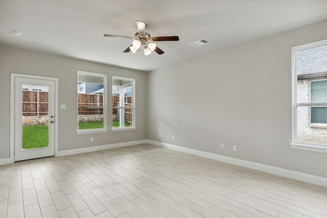 spare room with light hardwood / wood-style flooring and ceiling fan