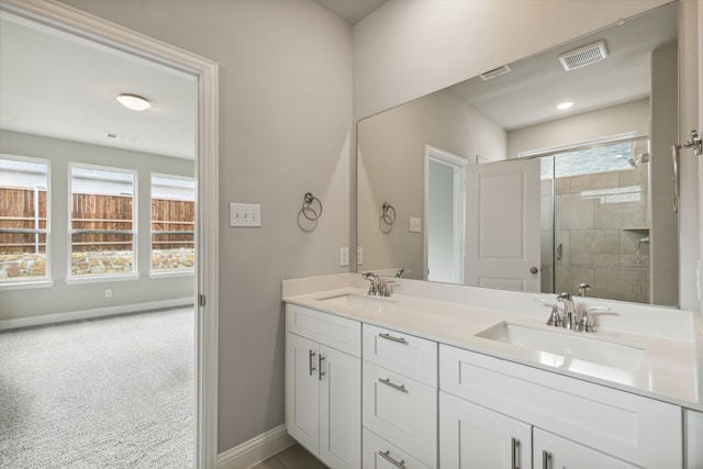 bathroom with walk in shower and vanity