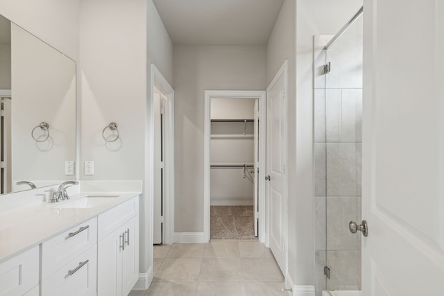 bathroom with vanity, tile patterned flooring, and a shower with door