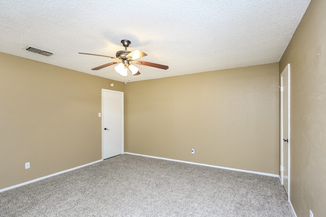 carpeted empty room with ceiling fan and a textured ceiling