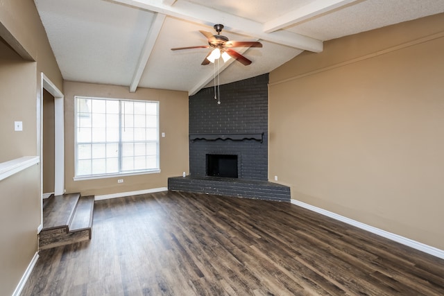 unfurnished living room with lofted ceiling with beams, ceiling fan, dark hardwood / wood-style flooring, and a fireplace