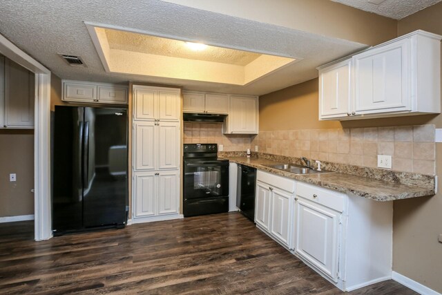 kitchen with sink, white cabinets, black appliances, and dark hardwood / wood-style floors