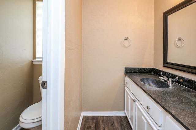 bathroom with vanity, wood-type flooring, and toilet