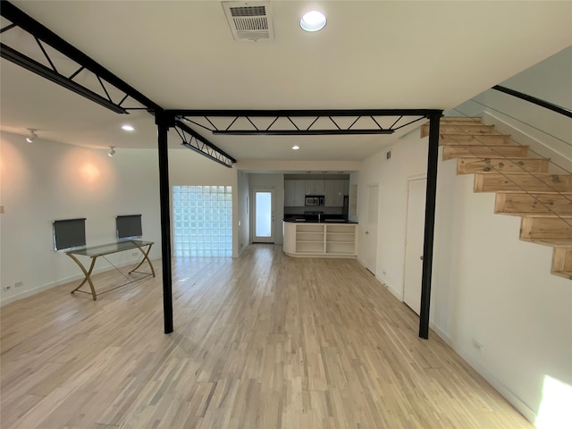 unfurnished living room with light wood-type flooring