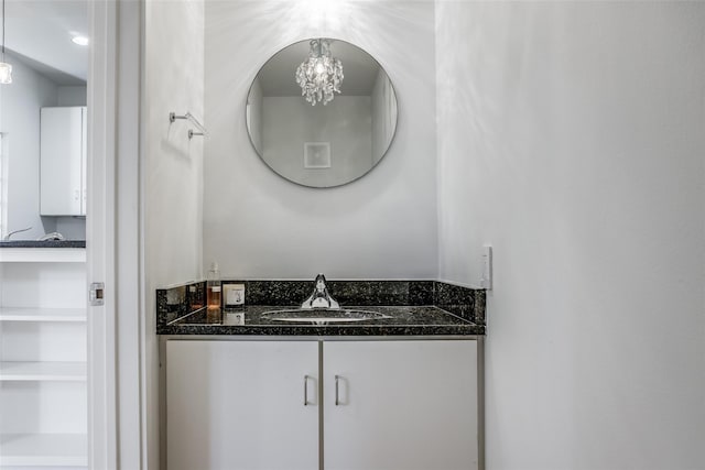 bathroom with vanity and a chandelier