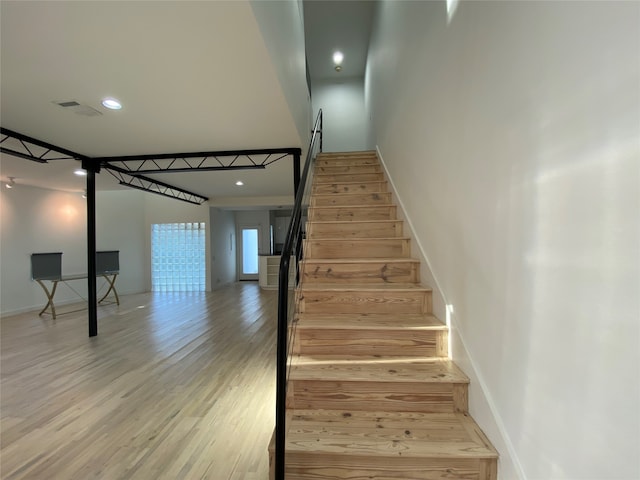 stairway featuring hardwood / wood-style flooring