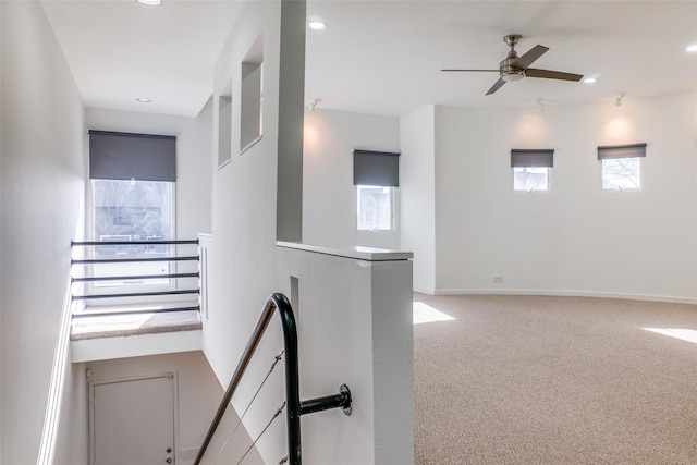 interior space with carpet flooring and ceiling fan