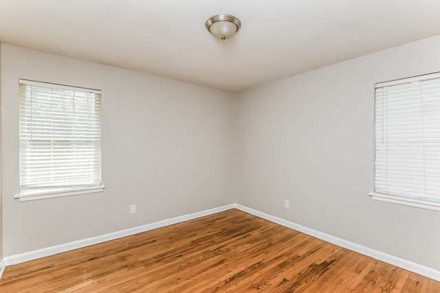 unfurnished room with wood-type flooring