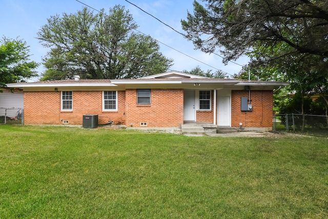 back of property with a yard and central AC unit