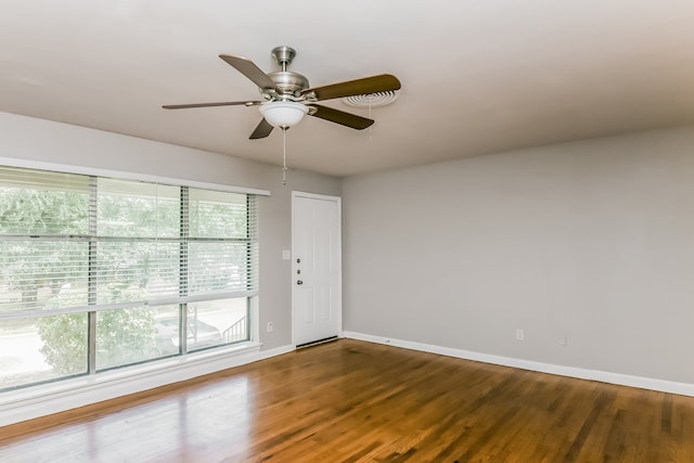 empty room featuring ceiling fan and hardwood / wood-style floors