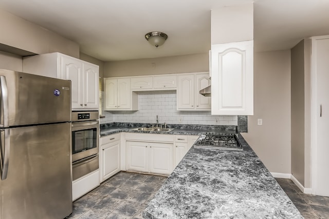 kitchen with sink, tasteful backsplash, white cabinetry, stainless steel appliances, and extractor fan