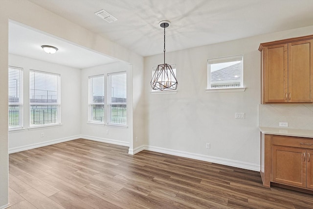 unfurnished dining area with light hardwood / wood-style floors