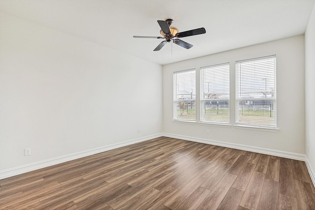 empty room with hardwood / wood-style flooring and ceiling fan