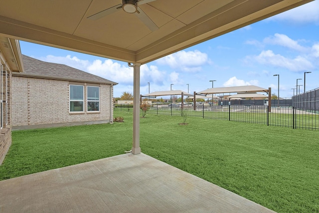 view of yard with ceiling fan and a patio area