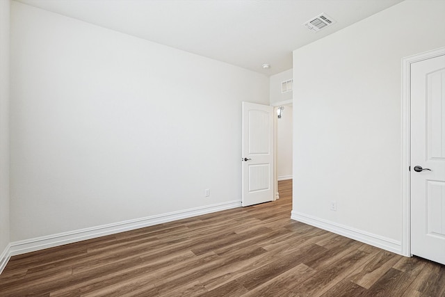 empty room with dark hardwood / wood-style floors