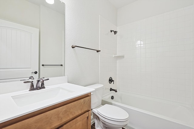 full bathroom featuring vanity, toilet, and tiled shower / bath