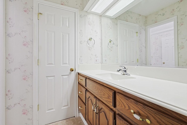 bathroom with vanity and a skylight