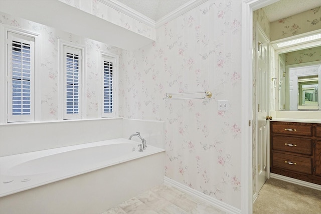 bathroom featuring vanity, a textured ceiling, ornamental molding, and a bathing tub