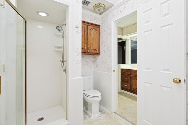 bathroom with walk in shower, vanity, and toilet