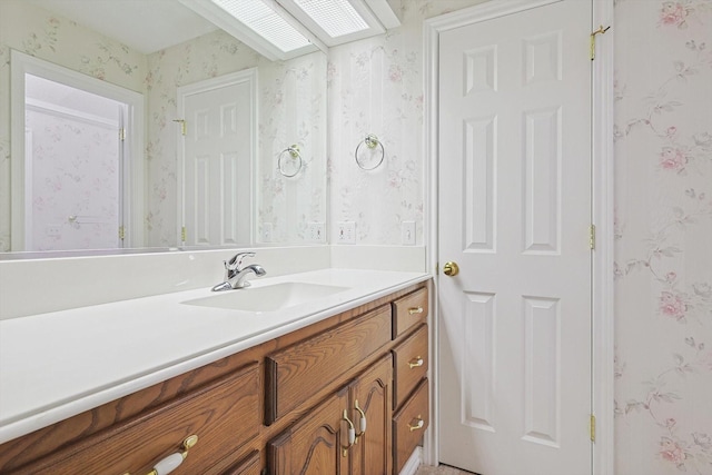 bathroom featuring vanity and a skylight