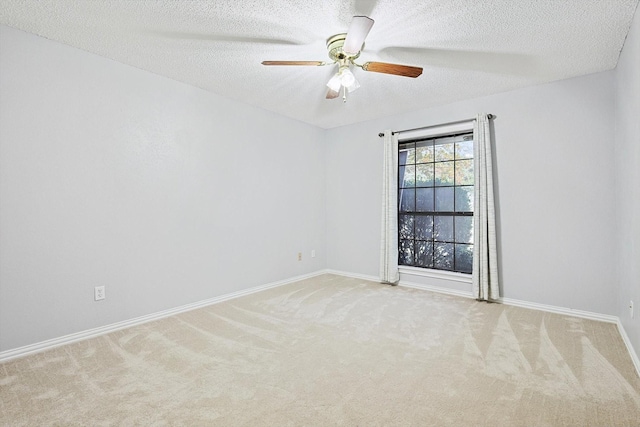 carpeted empty room with ceiling fan and a textured ceiling