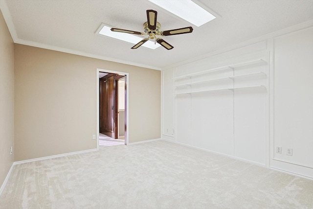 carpeted spare room featuring crown molding and ceiling fan