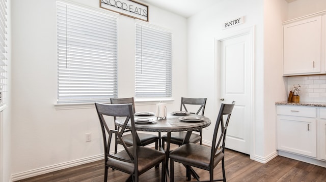 dining room with dark wood-type flooring