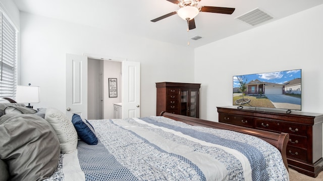 carpeted bedroom with ceiling fan and ensuite bathroom