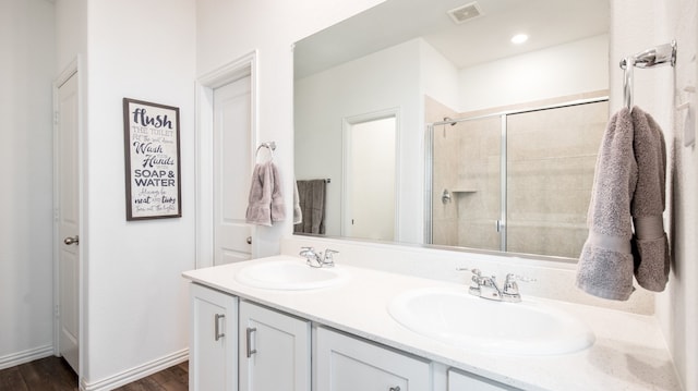 bathroom with vanity, wood-type flooring, and walk in shower