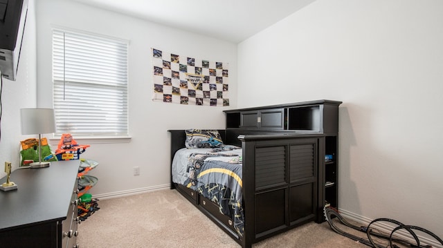 bedroom featuring light carpet and multiple windows