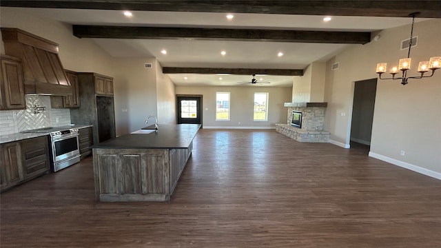 kitchen with stainless steel range, dark hardwood / wood-style flooring, ceiling fan with notable chandelier, and backsplash