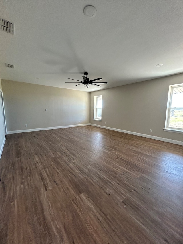 unfurnished room with ceiling fan and dark hardwood / wood-style flooring