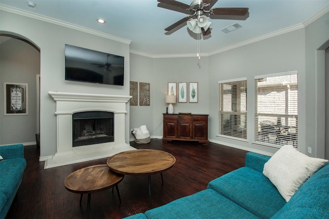 living room with dark hardwood / wood-style floors, ceiling fan, and crown molding