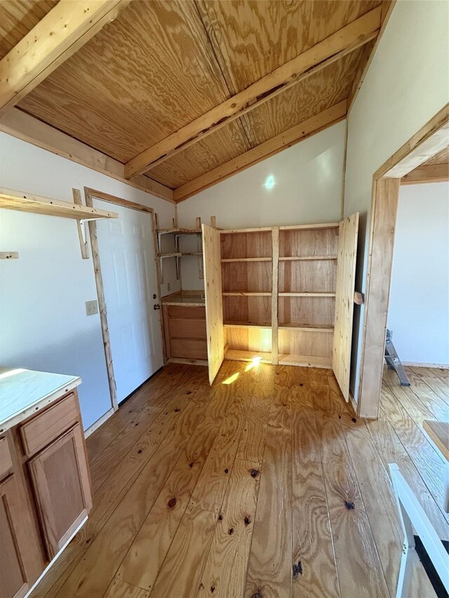 additional living space featuring ceiling fan, lofted ceiling with beams, light hardwood / wood-style flooring, and wooden ceiling