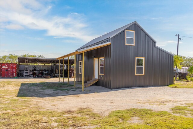 view of side of property with an outbuilding