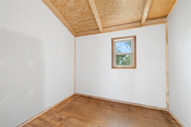 empty room featuring lofted ceiling, hardwood / wood-style floors, and wood ceiling