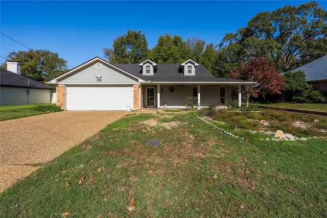 view of front of home featuring a porch, a garage, and a front yard