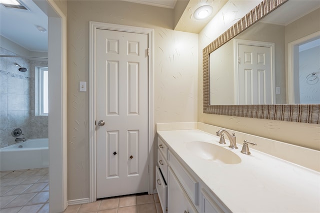 bathroom featuring tile patterned flooring, vanity, tiled shower / bath combo, and ornamental molding