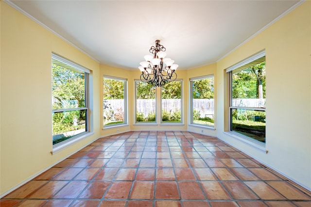 unfurnished sunroom featuring a healthy amount of sunlight and a notable chandelier