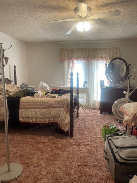 bedroom featuring ceiling fan, carpet, and a textured ceiling