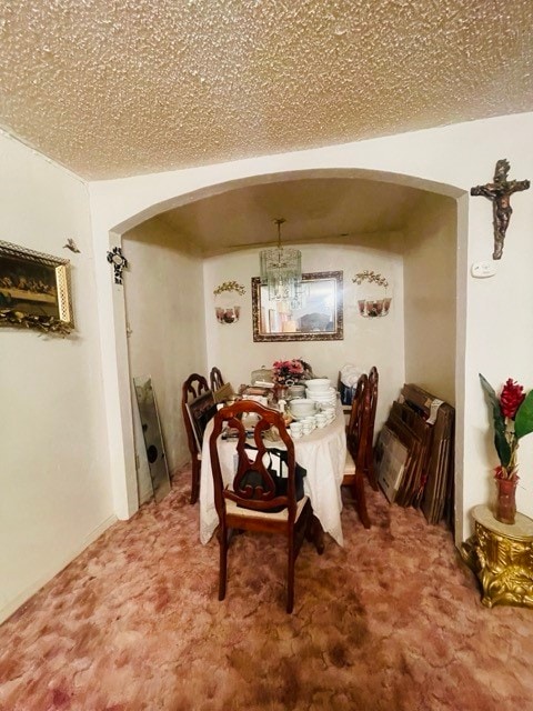 dining space featuring a textured ceiling