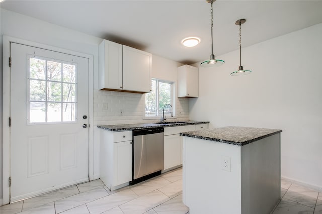 kitchen featuring white cabinets, decorative light fixtures, stainless steel dishwasher, and plenty of natural light