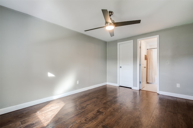 unfurnished bedroom featuring dark hardwood / wood-style flooring, ensuite bathroom, and ceiling fan