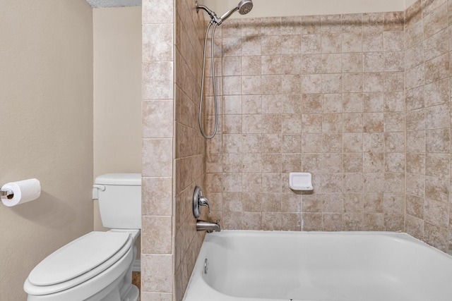 bathroom with tiled shower / bath combo and toilet