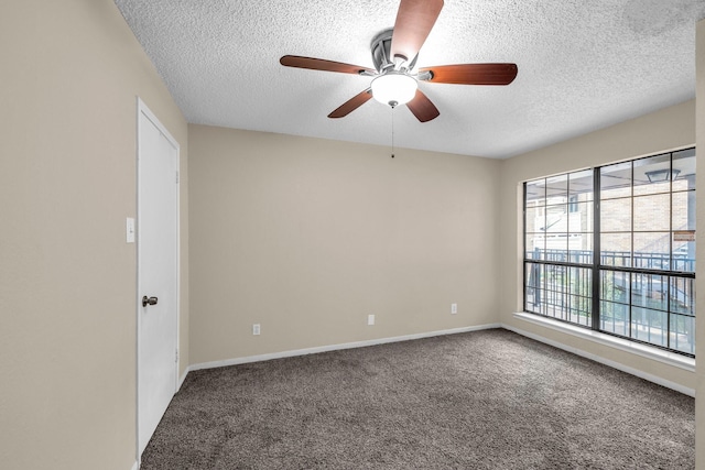 carpeted spare room with ceiling fan and a textured ceiling