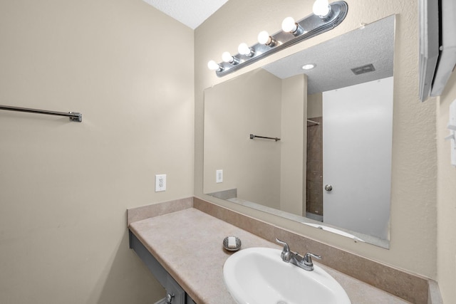 bathroom featuring vanity and a textured ceiling